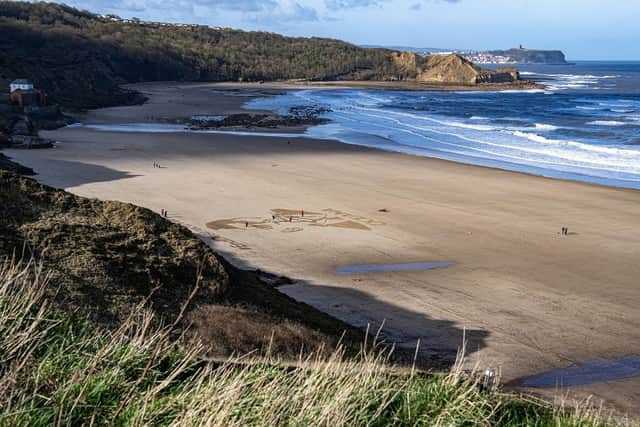 Liz Warrington and Peter McKenna from Sand in Your Eye work with land sand art at Cayton Bay near Scarborough. (Pic credit: Tony Johnson)