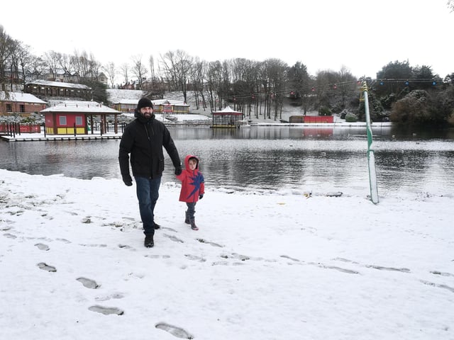 Dad and son enjoying a winter walk in Peasholm Park