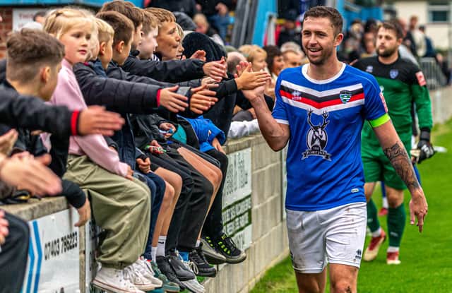 Whitby Town's Dan Rowe celebrates with the home fans after their FA Cup win against Morpeth Town. PHOTO BY BRIAN MURFIELD