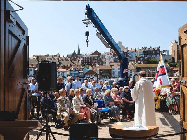 Father Michael Gobbett leads the service at Whitby lifeboat station. Photo: Ceri Oakes