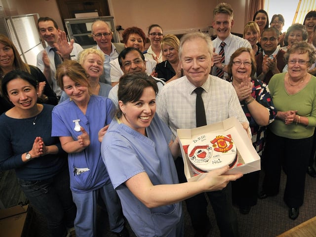 Scarborough Hospital Cardiologist Robert Clark retires - staff member Tania Neale presents a cake, cheered on by staff members and friends.
Picture: Richard Ponter