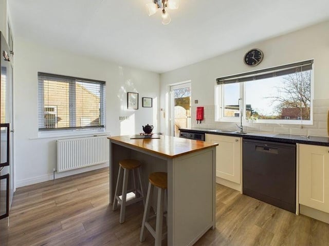 The modern kitchen has a central island with breakfast bar.