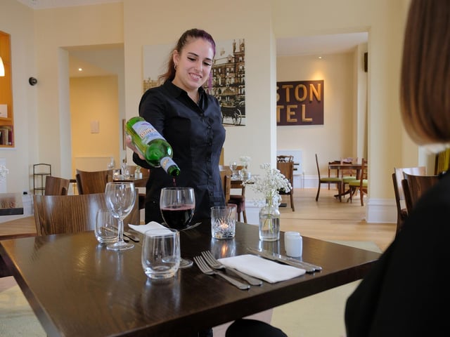 Clara serving a guest