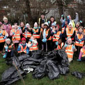 Staff, volunteers and pupils cheering after litter picking success.