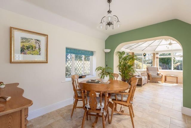 Bright dining through to sun room space.