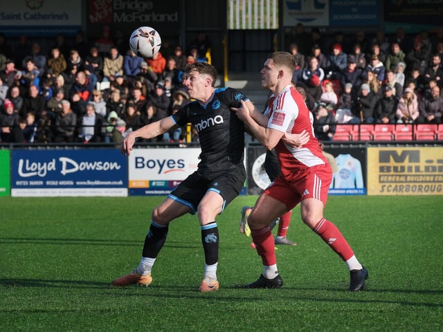 Scarborough Athletic defender Bailey Gooda gets to grips with a Chester player.