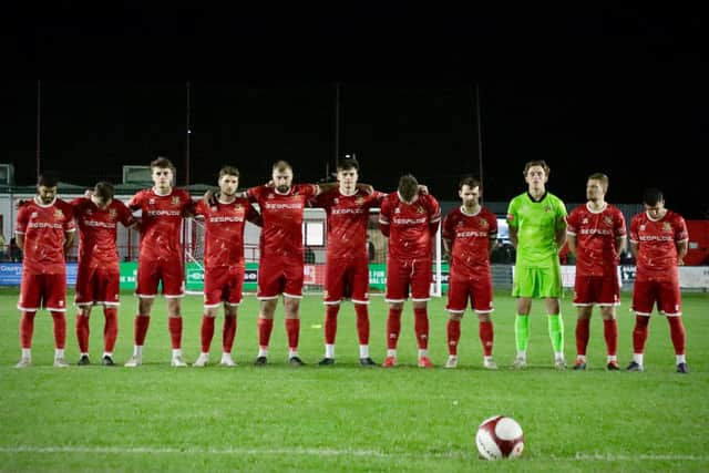 Bridlington Town players hold a minute silence in tribute to sporting legend Cyril Skinner before kick-off. Photo by TCF Photography