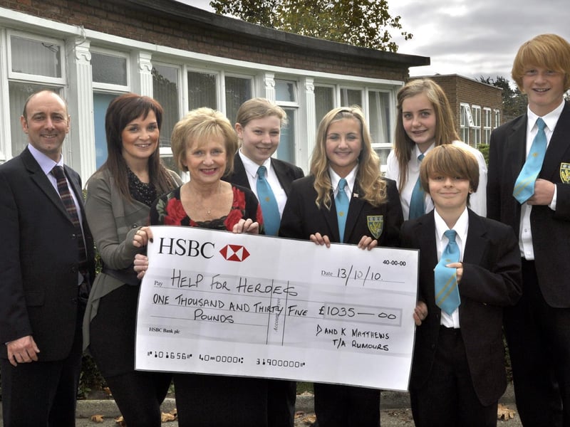 Scalby School pupils get new ties. From left: head David Read, Caron and Denise Matthews of Rumours and pupils Sally Kirk, 13, Kaya Hutchinson, 13, Hanna Scholes, 15, Chris Archer, 11, and Tyler Richardson, 14. Photo: Dave Barry 104120a