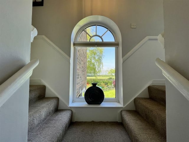A feature arched window on the half-landing.