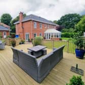 The Newby property has wrap-around gardens with seating areas.