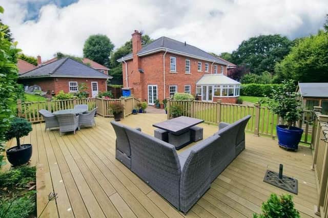 The Newby property has wrap-around gardens with seating areas.
