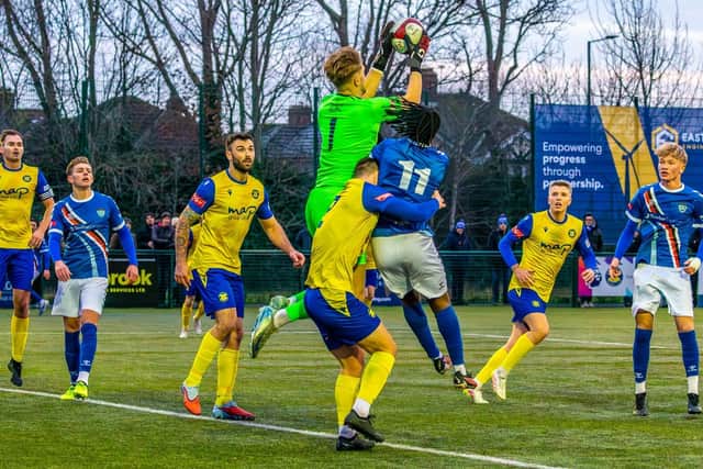 Stockton get to grips with Whitby forward Donald Chimalilo. Photo by Brian Murfield