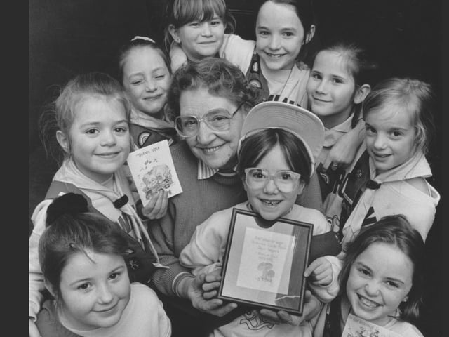 Pictured is Jean Rogers, centre, the retiring Brown Owl of the 2nd Westborough Brownies and Guides in March 1992. Jean is surrounded by some of her Brownies who show off some her leaving cards and a framed gift.