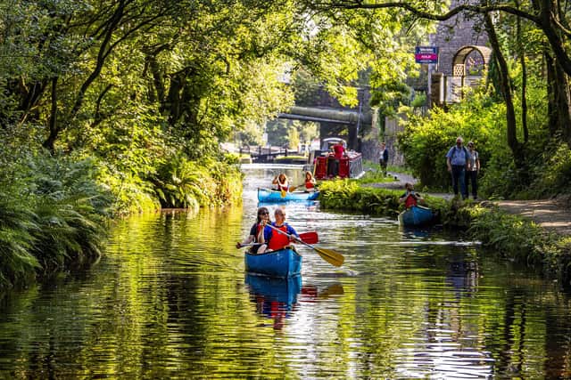 Staff and volunteers at the Canal and River Trust take the opportunity for taster canoe trips on the Huddersfield Narrow Canal at Standedge Tunnel and Visitor Centre at Marsden near Huddersfield