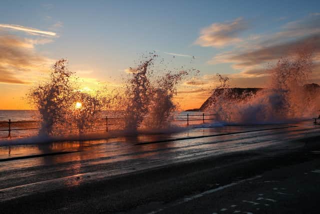 Waves splashing over the top on to the road. photo: Beverley Senturk