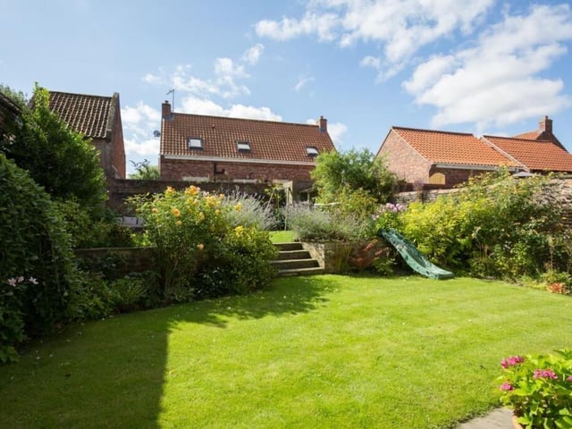 An established two-tier garden with filled borders.