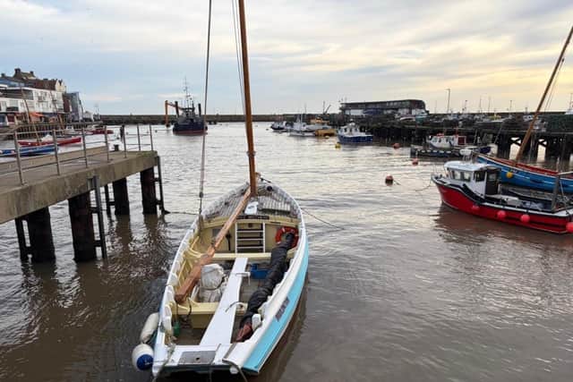 Ian Sandy focuses on a coble in the harbour.