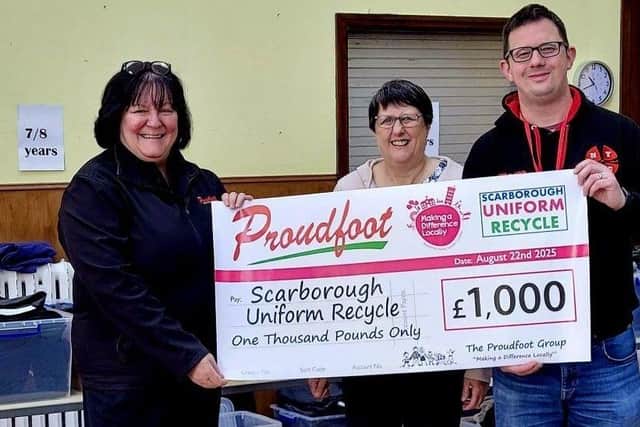 Valerie Aston (left) presents a cheque for £1,000 to Scarborough Uniform Recycle.