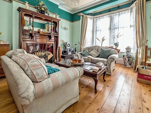 A stunning feature fireplace with living flame gas fire, and a walk-in bay window bring character to this front facing lounge.