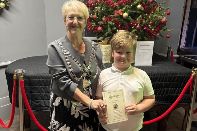 Whitby Mayor Sandra Turner presents Lucas Leighton with his award, for volunteering in Pannett Park cleaning the lily pond.