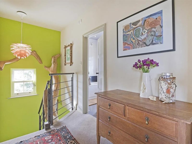 The oak tree, intertwined with the wrought iron staircase, reaches above the landing.