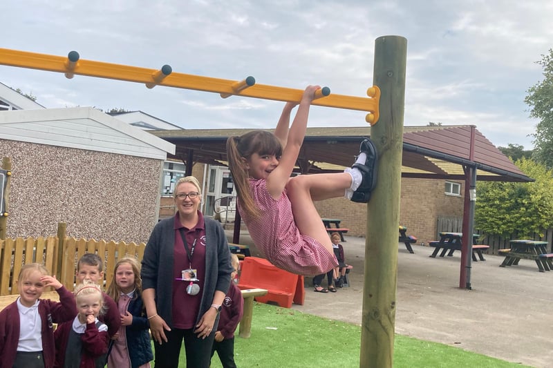 This little monkey was showing off her monkey bars skills to her classmates.