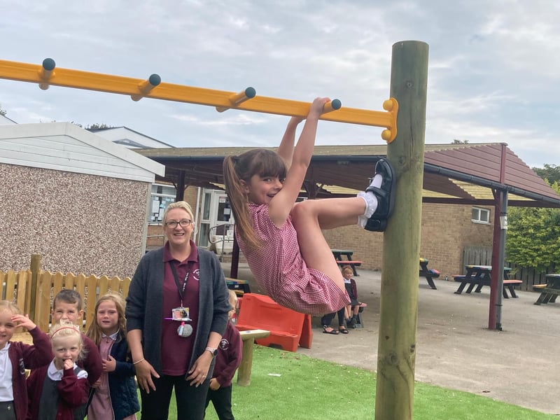 This little monkey was showing off her monkey bars skills to her classmates.