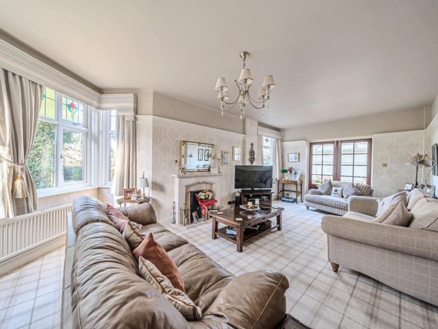 A bright and spacious lounge with feature fireplace.
