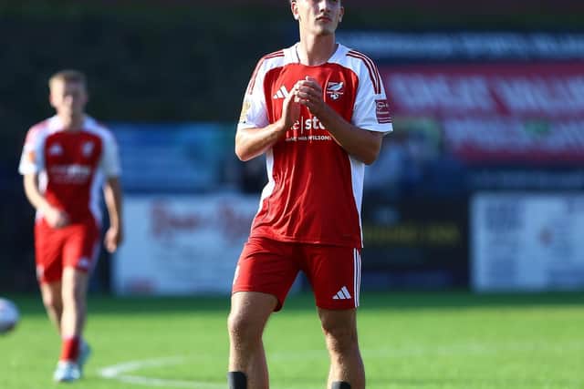 New signing Mackenzie Maltby, who made his debut as a sub, applauds the fans.