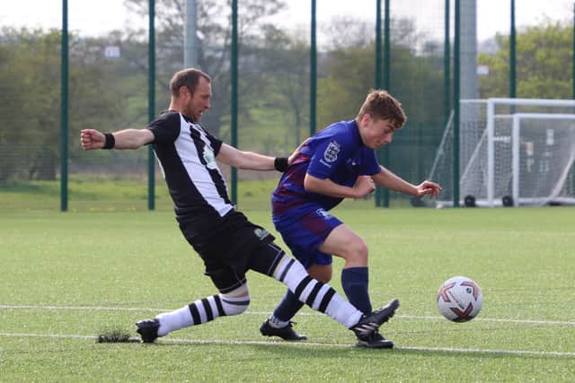 Hornsea Town Reserves nick the ball away from the home side.
