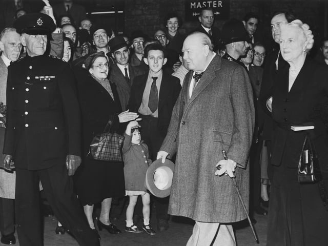 Crowds welcome British statesman Winston Churchill (1874 - 1965) and his wife Clementine (1885 - 1977) as they arrive at King's Cross station, October 9, 1952. The couple are travelling to the Conservative Party conference at Scarborough.