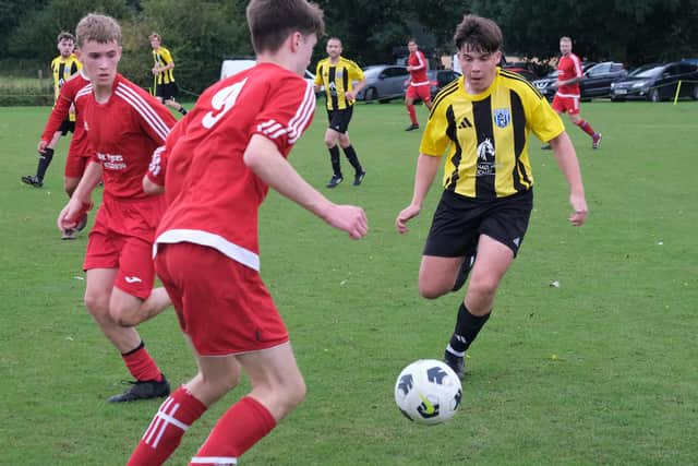 Scalby, yellow and black kit, close down Richmond Academy in the cup clash.