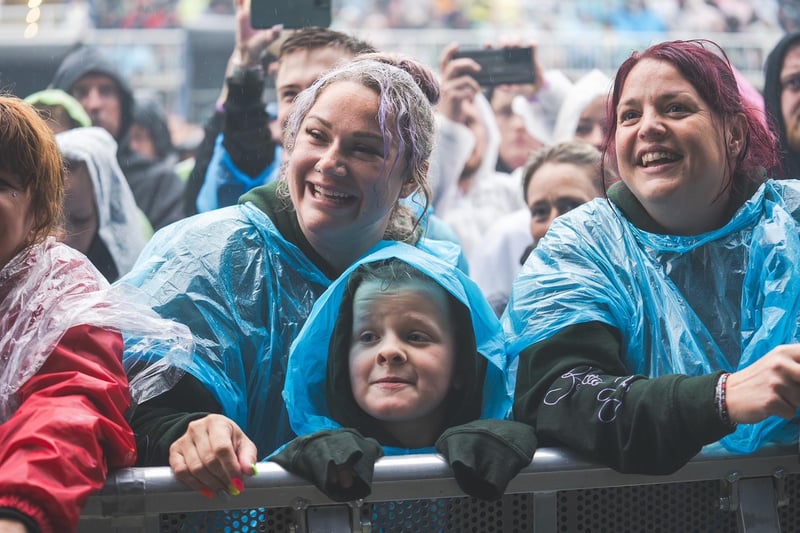 All smiles as the crowd watches Dermot Kennedy singing in the rain.