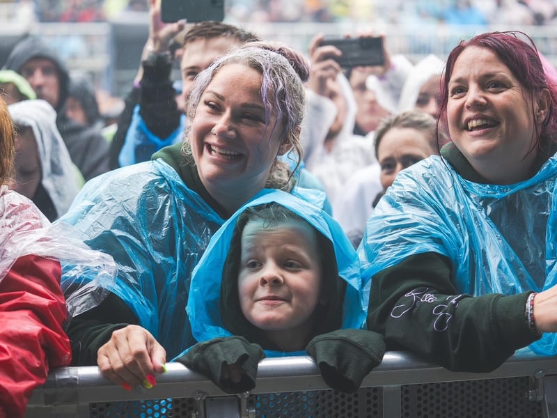 All smiles as the crowd watches Dermot Kennedy singing in the rain.