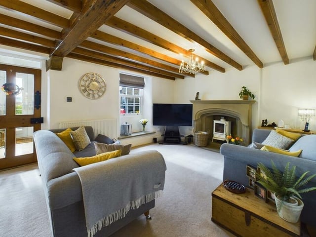 The beamed lounge has a feature stone fireplace.
