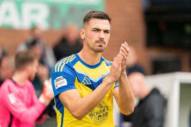Boro skipper Will Thornton applauds the visiting fans at his 200th competitive appearance for the Seadogs, the 3-2 win at Ling's Lynn Town. Photo by Wandering Photography
