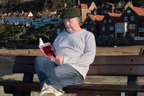 Whitby resident Andy McKnight reading at Whitby Harbour.   Photo: Paul Armstrong, The Artistic Lens