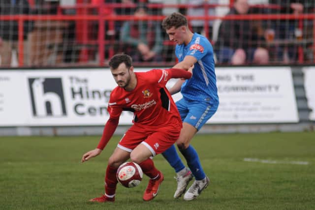 Scorer Lewis Dennison looks to shake off the attentions of a Newton Aycliffe defender during the NPL East clash at Queensgate. PHOTOS BY DOM TAYLOR