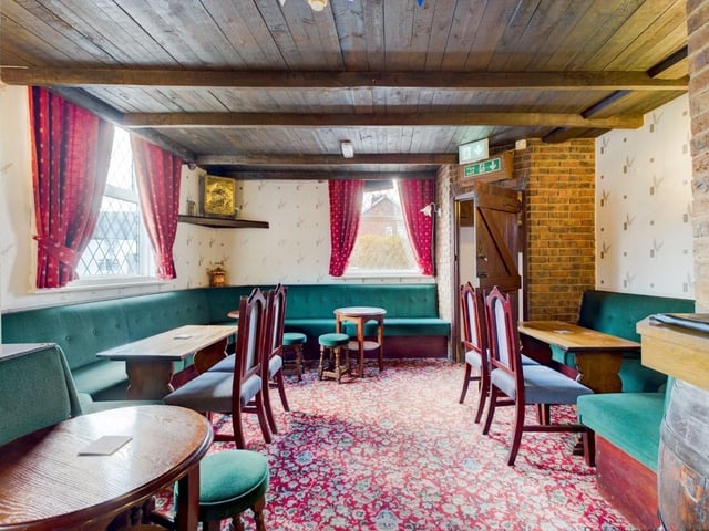 A beamed lounge area inside the pub.