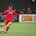 Scarborough Athletic's Kian Spence delivers a dangerous cross into Bamber Bridge's box.