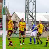 Whitby Town's Adam Gell (third from right) curls ball into goal to put the home side 2-0 ahead against Prescot Cables in the FA Cup clash. PHOTOS BY BRIAN MURFIELD