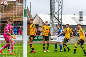 Whitby Town's Adam Gell (third from right) curls ball into goal to put the home side 2-0 ahead against Prescot Cables in the FA Cup clash. PHOTOS BY BRIAN MURFIELD