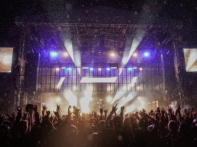 The intricate light show illuminated the rain as it pelted down on the uncaring fans.