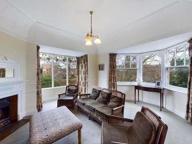 The sitting room boasting more beautiful bay windows.
