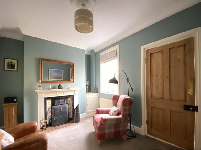 Relax in this snug with a large window and an open fire with feature fireplace.