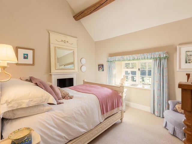 One of the beamed bedrooms within the cottage.