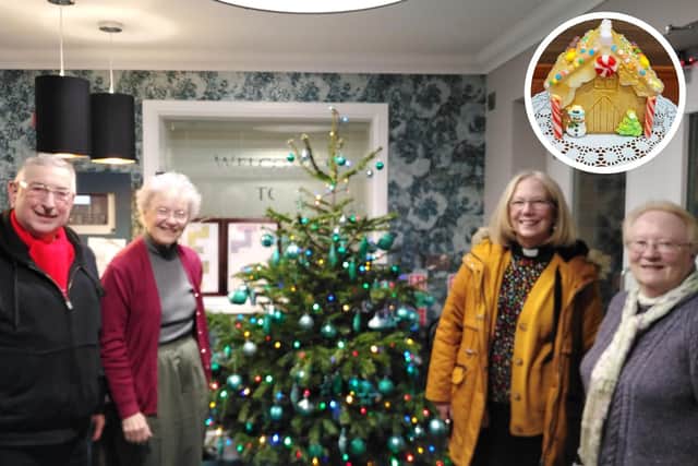 Members of St James Church pose for a photo together beside the Christmas tree at Scarborough Hall’s reception after visiting residents in their bedroom’s for a tailored Christmas Carol experience.