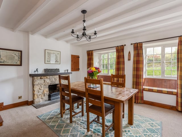 The light and spacious dining room with feature fireplace.