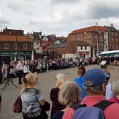 The crowd at Whitby's Dock End await the Proclamation of Accession of King Charles III.
