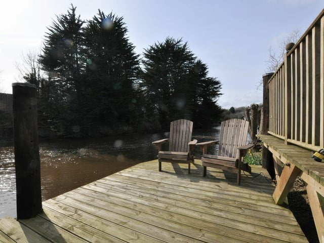 Relax and enjoy the views by the river on private decking that leads directly to the water.